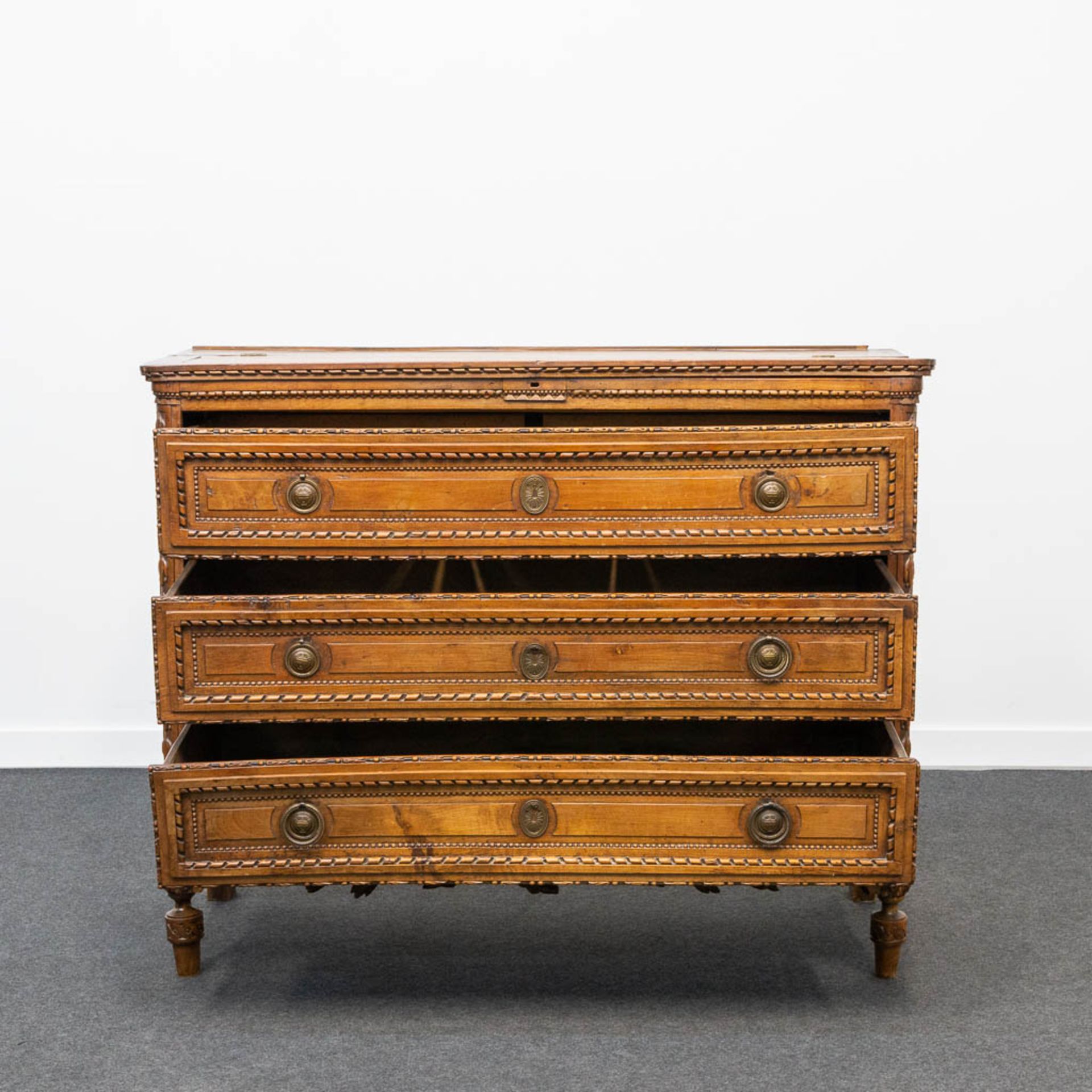 A wood sculptured commode in Louis XVI style, with 3 drawers and a hidden desk. 18th century. - Image 2 of 23