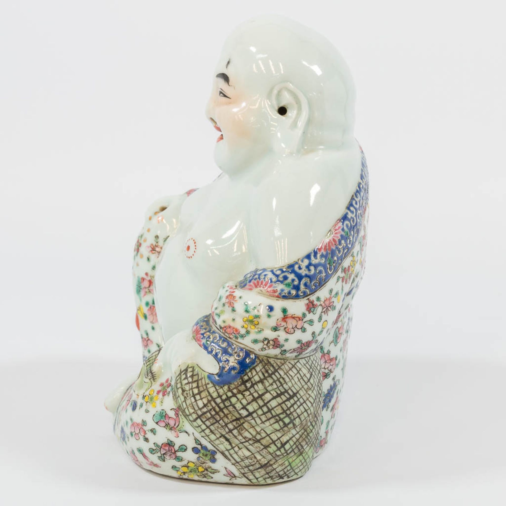 A Chinese laughing buddha, made of porcelain. - Image 4 of 27