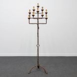A Wrought iron candlestick with 10 points of light, which has been transformed to standing lamp.