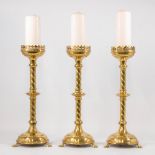 A collection of 3 church candlesticks, made of bronze.