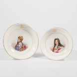A collection of 2 porcelain Tazza's with an image of Charlesmagne and Louis XIV.
