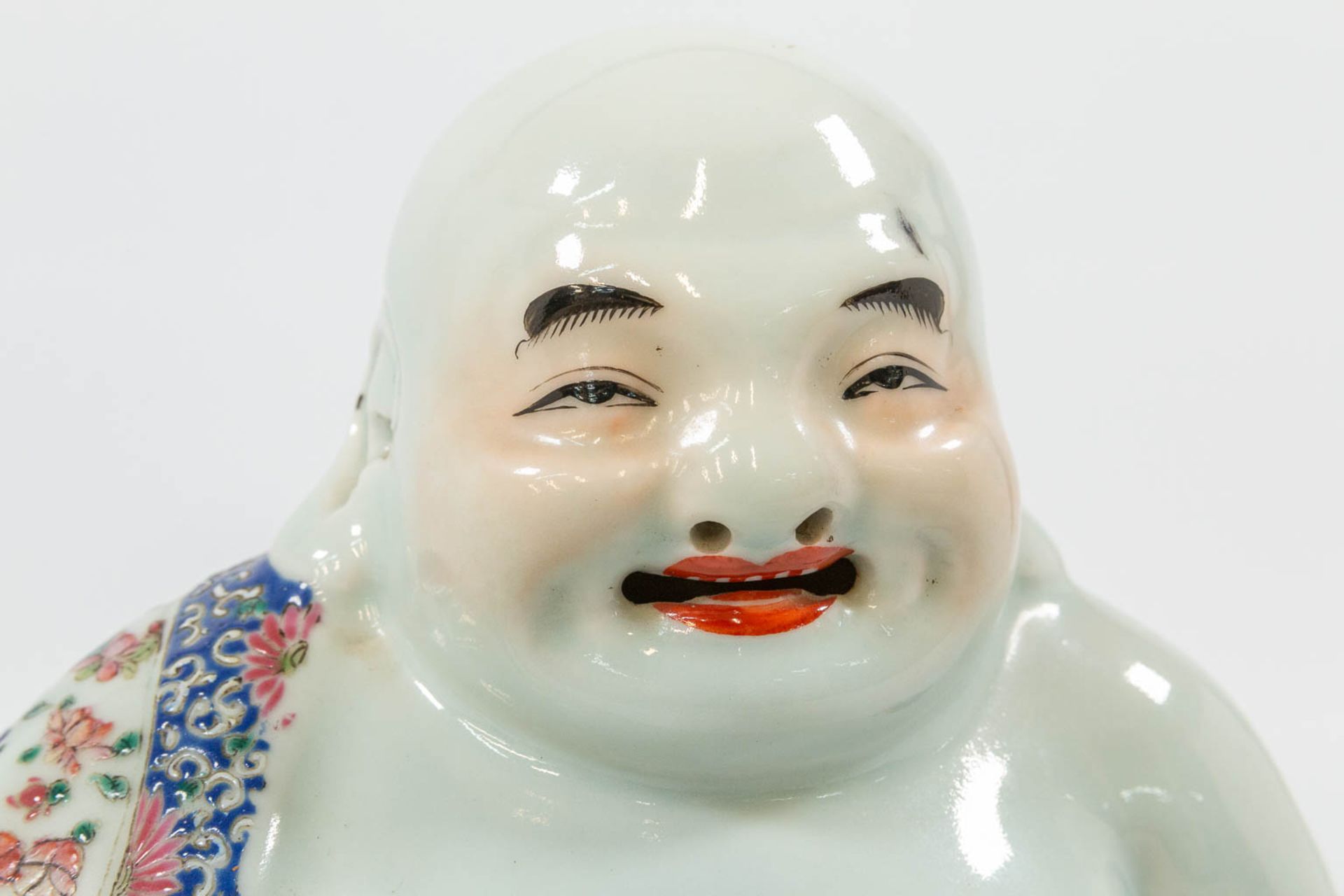 A Chinese laughing buddha, made of porcelain. - Image 2 of 27