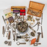 A collection of tools, lathe and small parts for a watchmaker.
