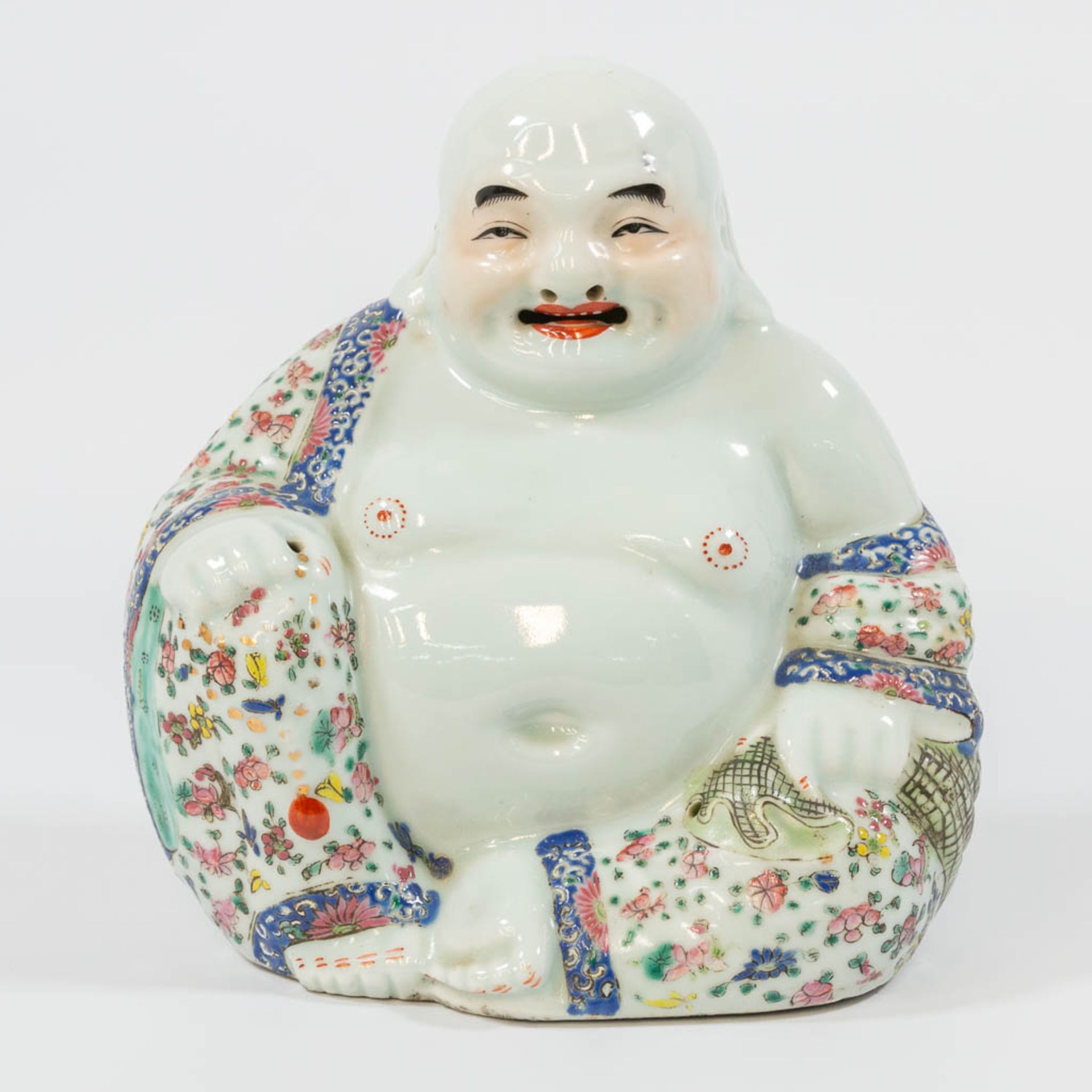 A Chinese laughing buddha, made of porcelain.