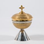 An antique, silver ciborium.