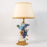 A table lamp with porcelain bird on a metal stand, marked with a Sèvres porcelain mark.