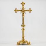 A Large bronze crucifix, decorated with semi precious stones, standing on a base of lions.