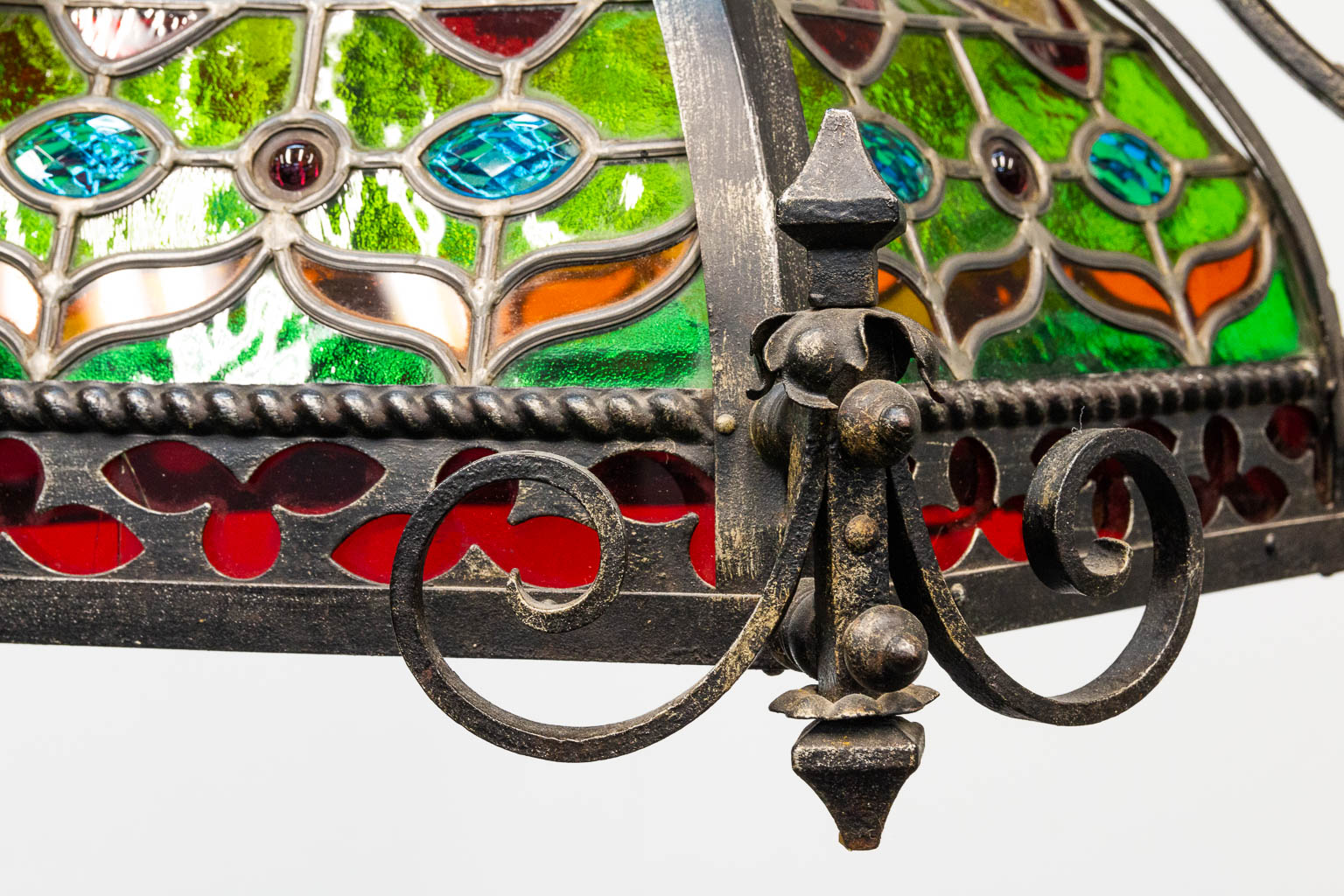 A wrought iron and stained lead glass chandelier. - Image 8 of 12