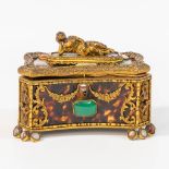A jewelry box, made of gillt bronze and tortoise shell, decorated with semi-precious stones.