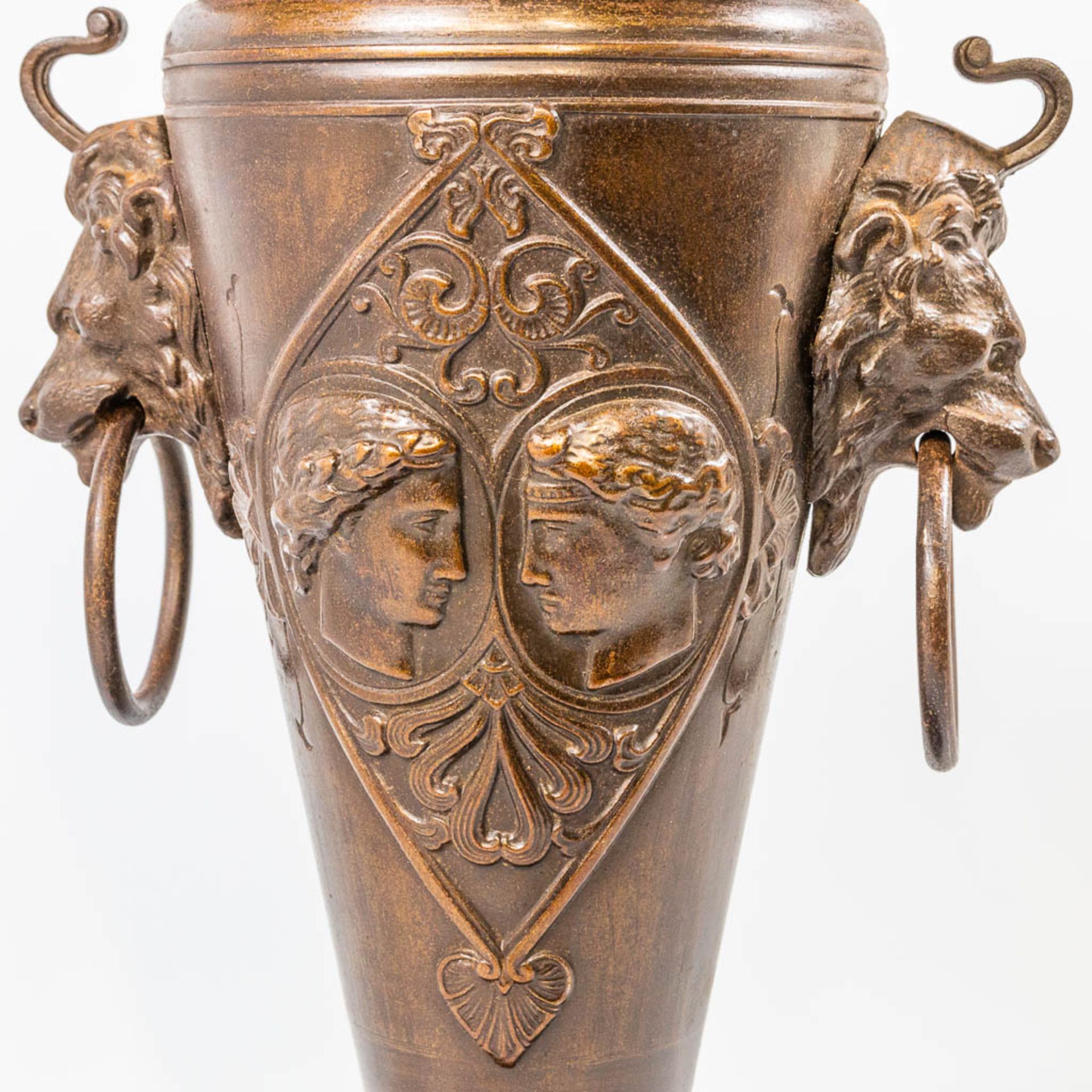 A cast-iron vase, decorated with silhouettes of faces, lion's heads and standing on a plate. France - Bild 10 aus 16