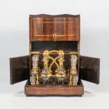 An antique Cave à Liqueur / Liquor box, made of wood inlaid with brass and a set of decanters with g