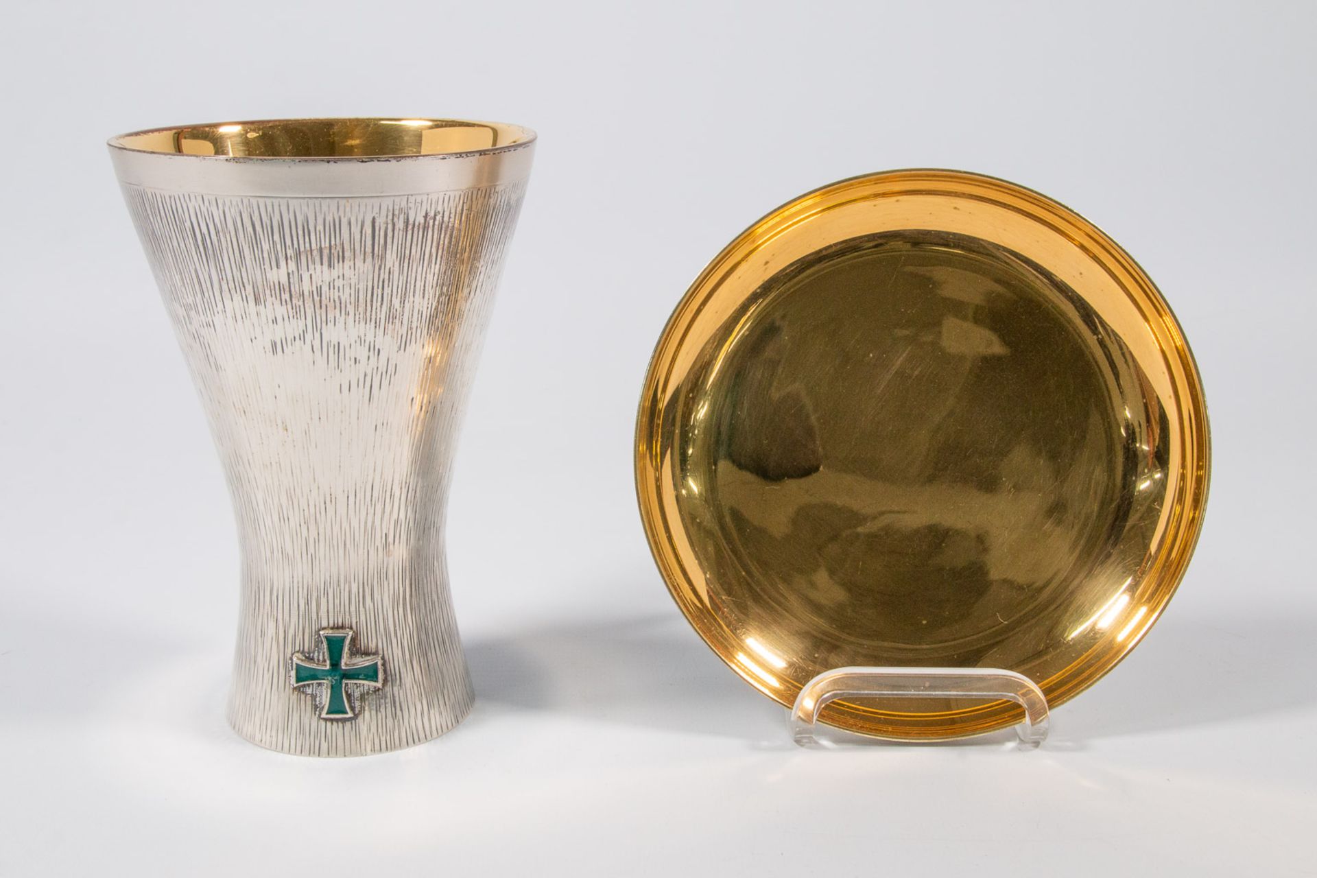 A chalice and paten in original chest, silver.