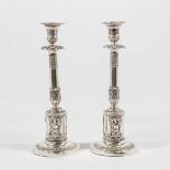 A pair of candlesticks made of solid silver.