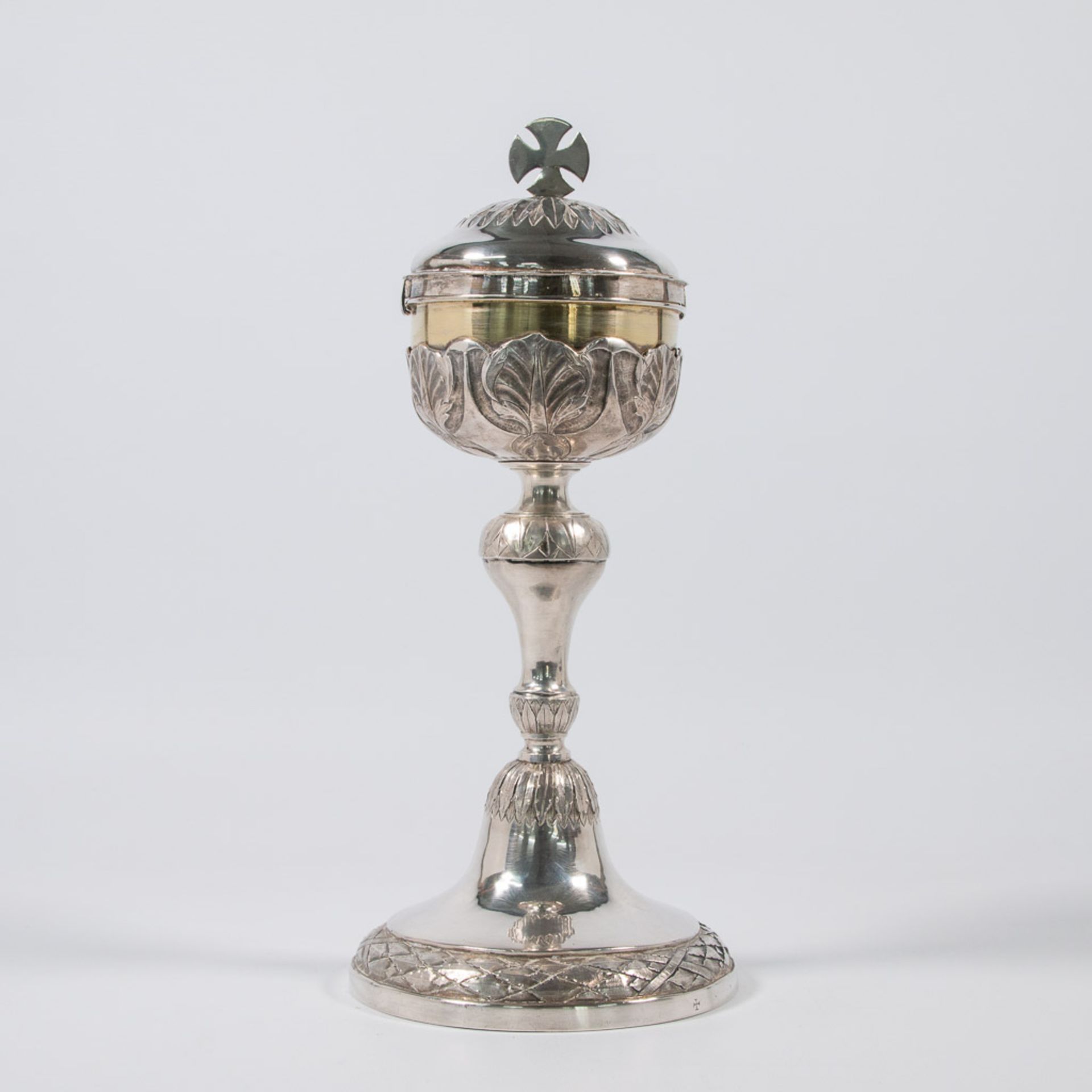 An antique, silver ciborium.