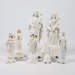 A collection of 7 bisque porcelain holy statues, Mary, Joseph, and Madonna.