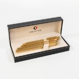 A Sheaffer fountain pen with 14kg gold nib, 2 ballpoint pens and a pencil in their original case.