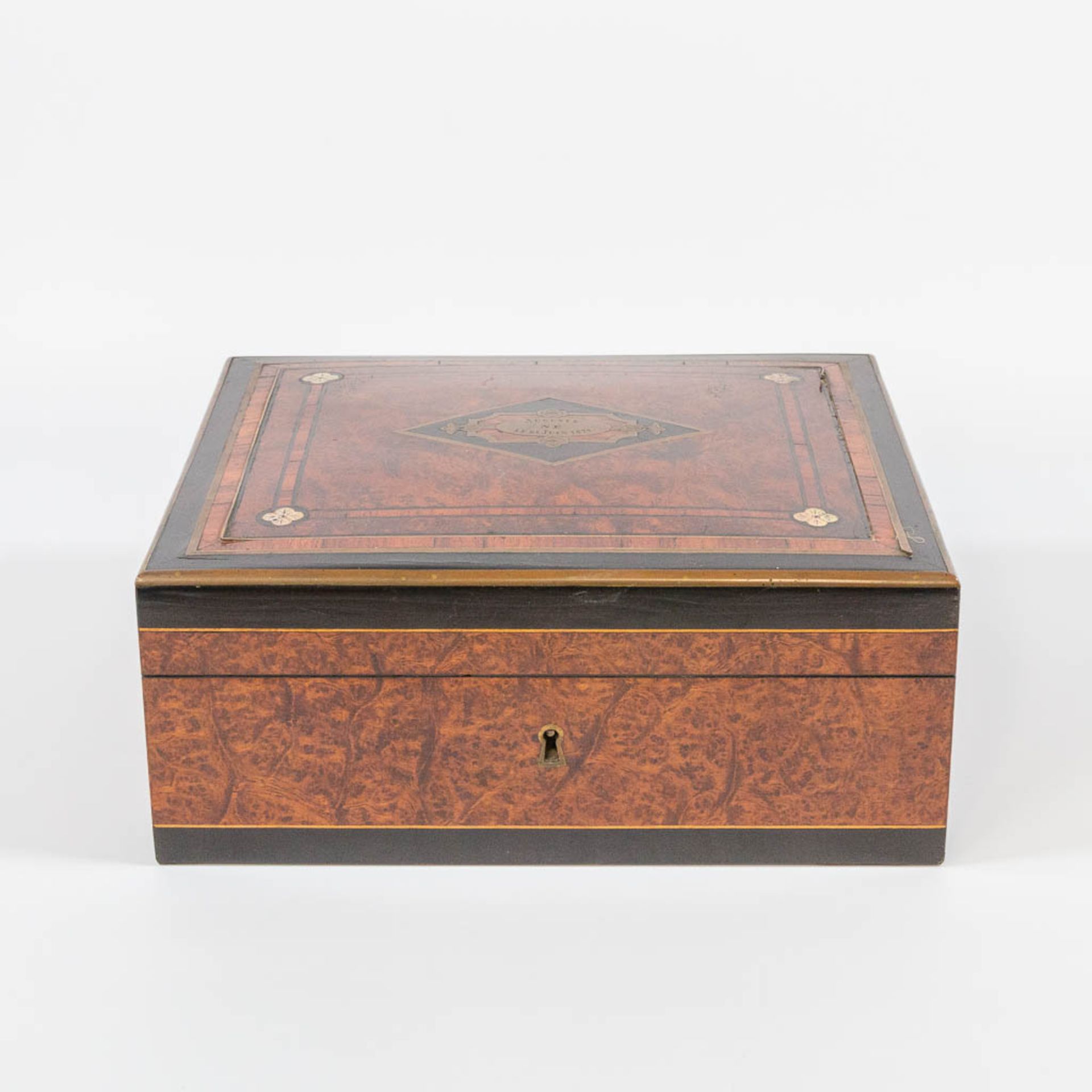 An Antique storage box, with inlaid ebony, root wood and cherry wood with brass. Marked Auguste 1877