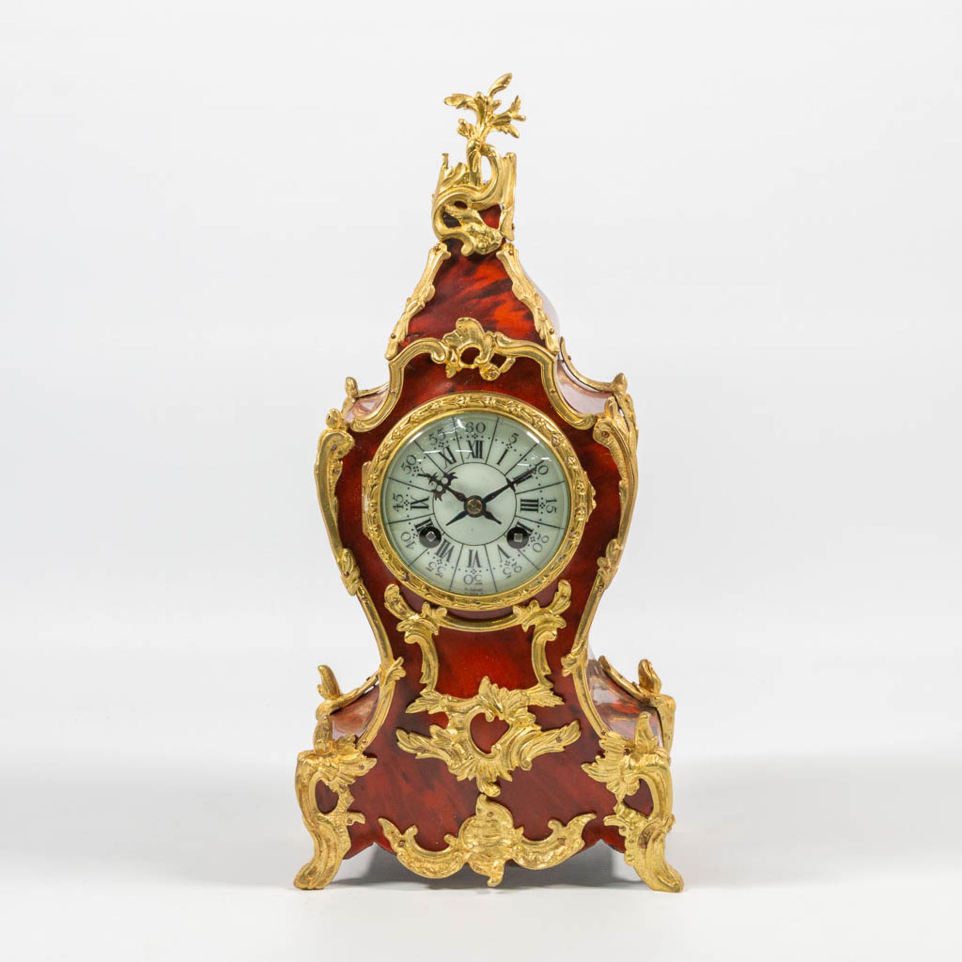 A Table clock made of wood decorated with Tortoise shell and Mount