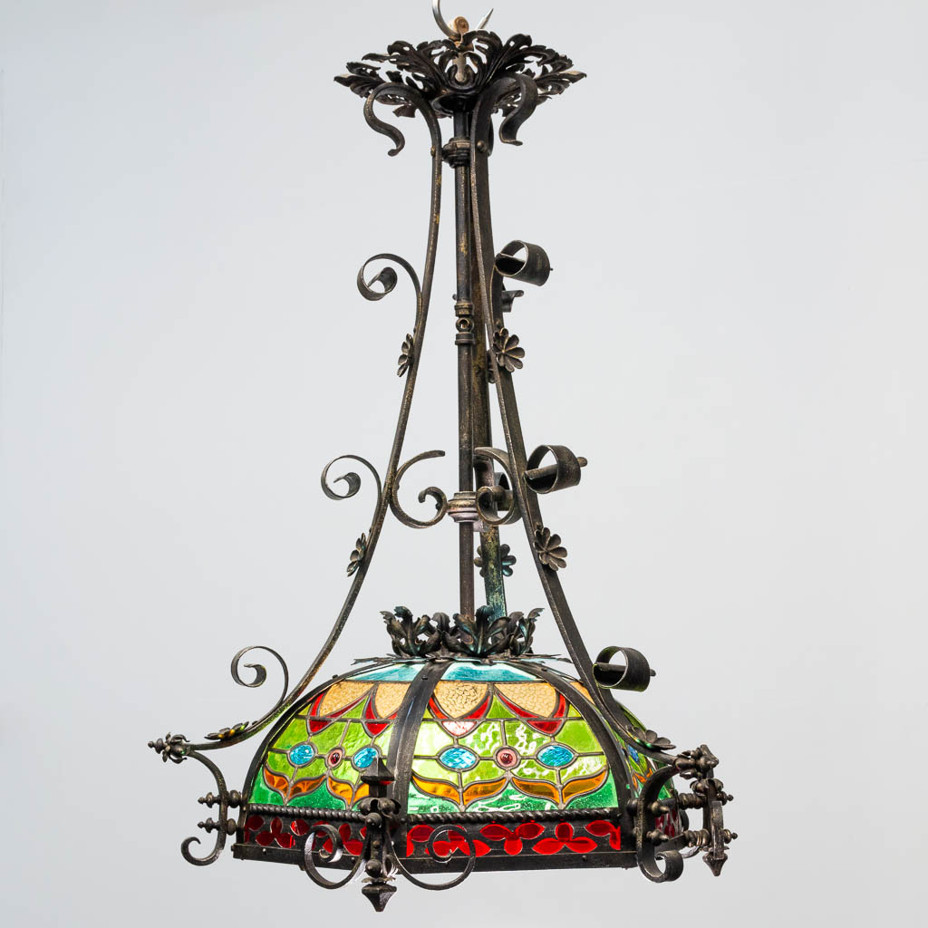 A wrought iron and stained lead glass chandelier. - Image 4 of 12