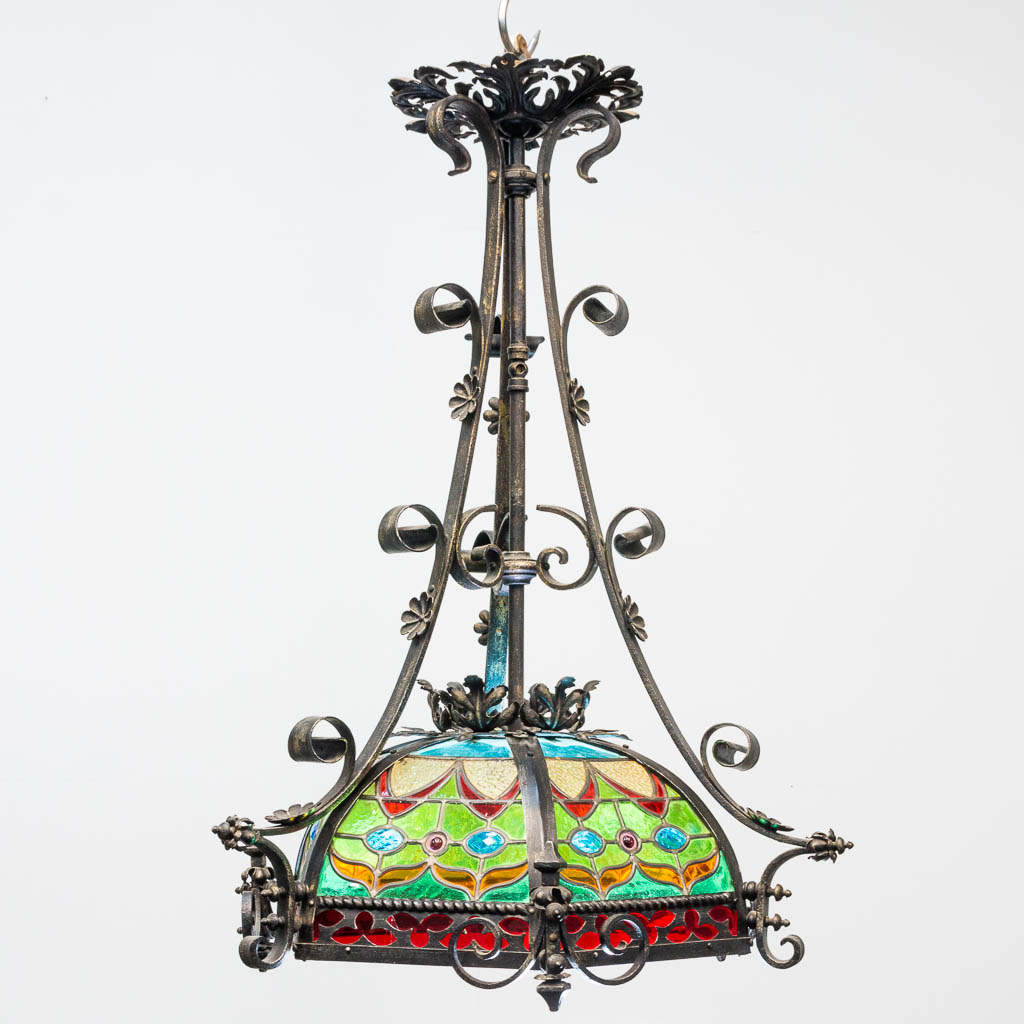 A wrought iron and stained lead glass chandelier. - Image 2 of 12