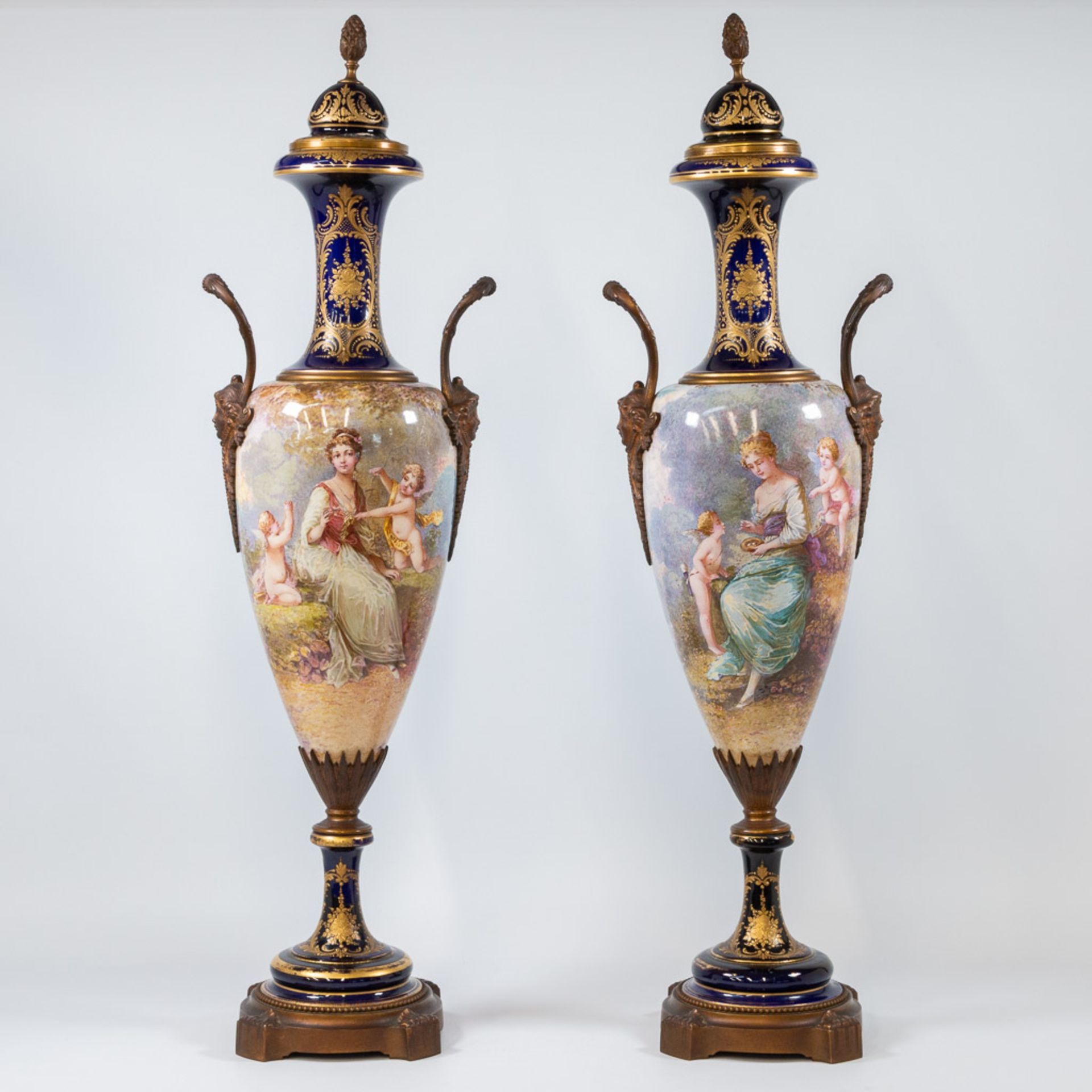 A pair of Sèvres vases with lid, cobalt blue with a decor of ladies and landscapes. 19th century.