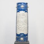 A large blue and white Chinese vase, with white relief decor of peonies