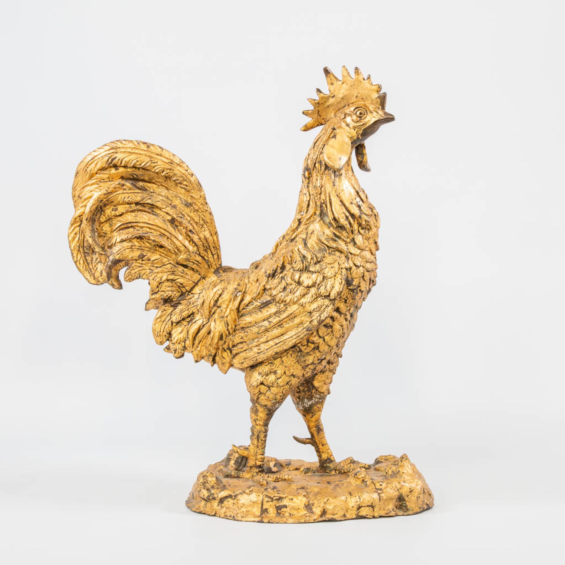 A gold plated bronze statue of a rooster.