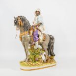 A porcelain statue of a horseback rider, made by Capodimonte.