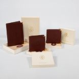 A Must De Cartier, collection of 3 wallets with their original boxes.