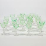 A collection of 22 crystal 'uranium glasses': a set of 18 and 4 pieces. Glowing bright green under U