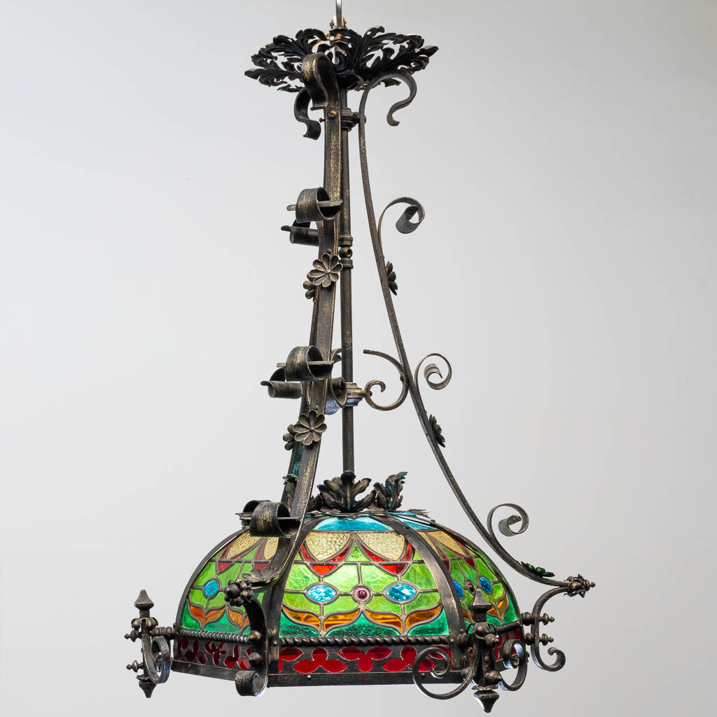 A wrought iron and stained lead glass chandelier. - Image 3 of 12