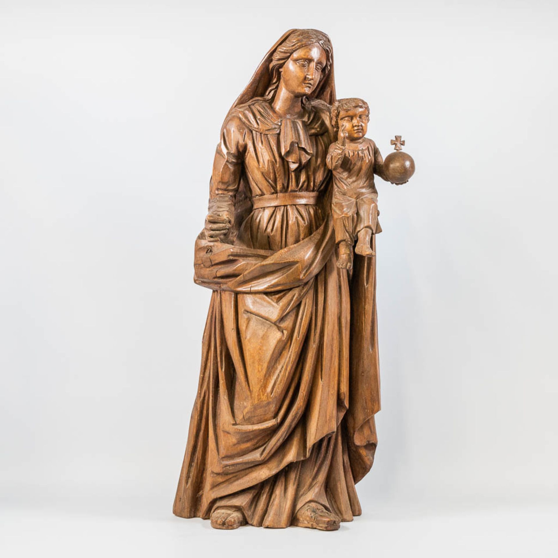 A wood sculptured Mary and Jesus figurine with globus cruciger. 19th century.