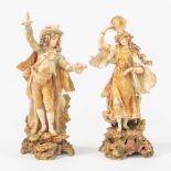 A pair of porcelain figurines, male and female in traditional clothing, Ilmenau Germany.