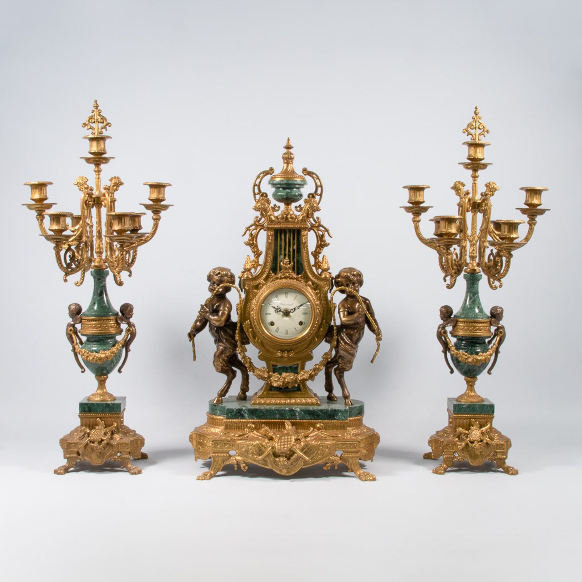 An Empire style 3-piece mantle clock with green marble and bronze.