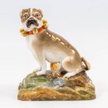 A porcelain statue of a dog with a puppy marked Jacob Petit. 19th century. (8 x 13 x 15 cm)