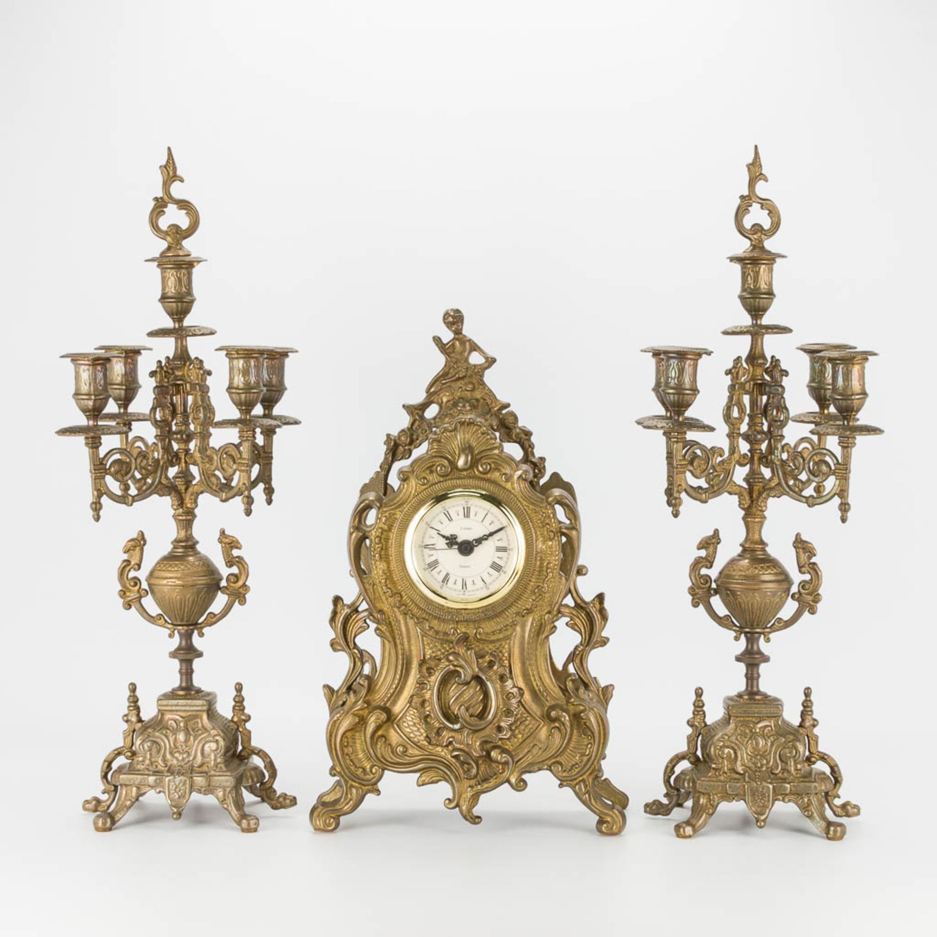 A bronze 3-piece garniture with clock and candelabra. The second half of the 20th century. (22 x 22