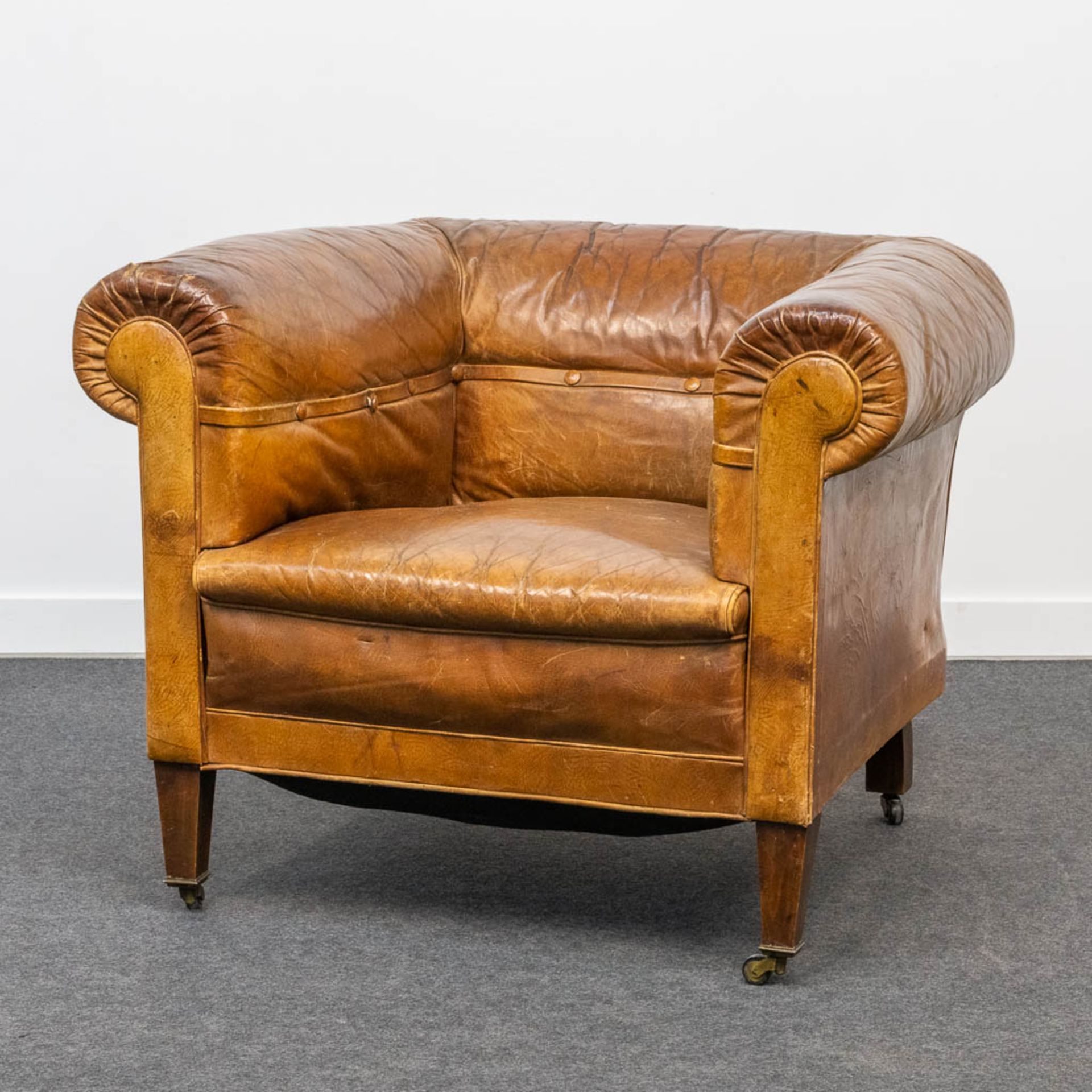 An antique leather club sofa. The first half of the 20th century. (85 x 88 x 70 cm)