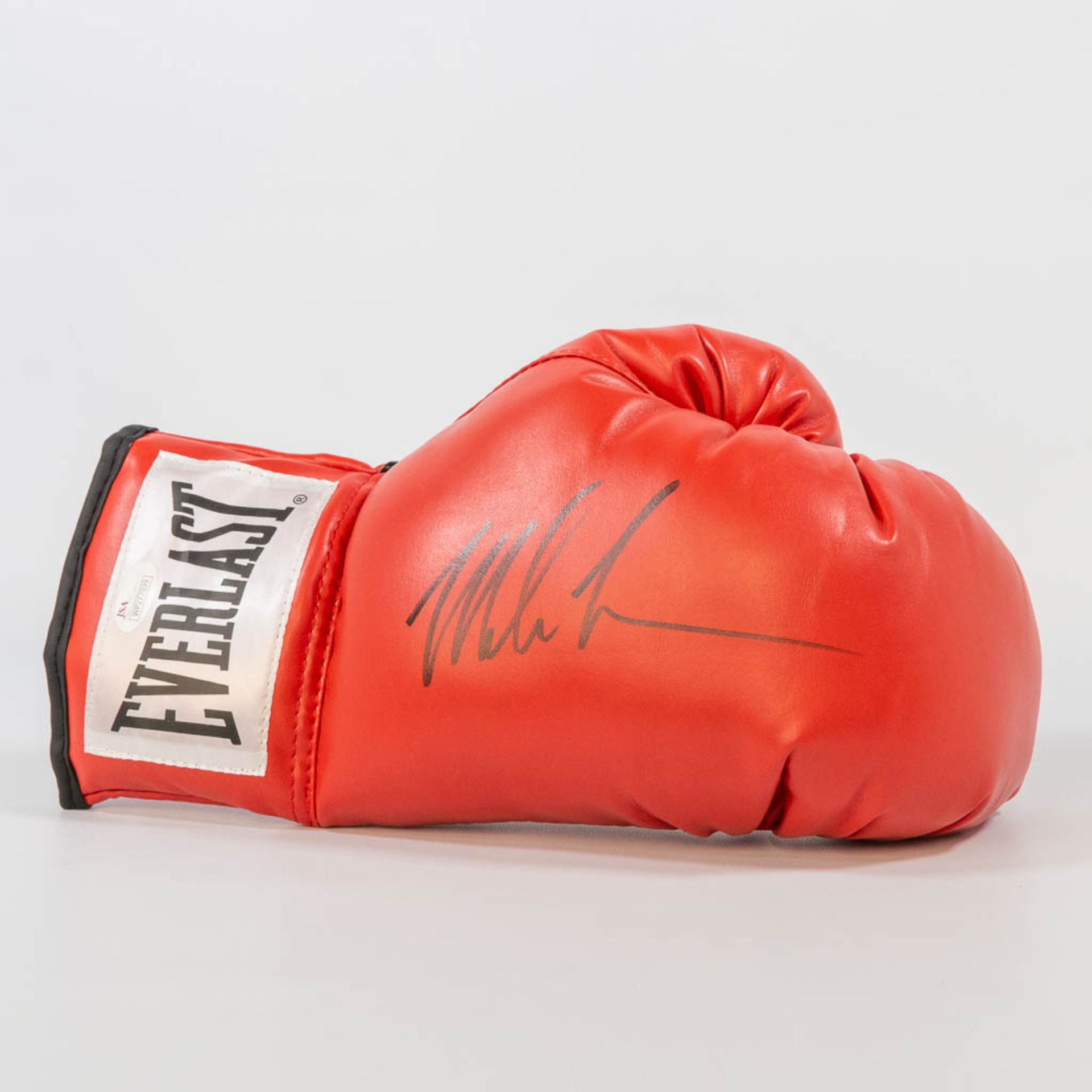 A signed boxing glove by Mike Tyson, with a JSA Witness Protection program certificate. (11 x 32 x 1