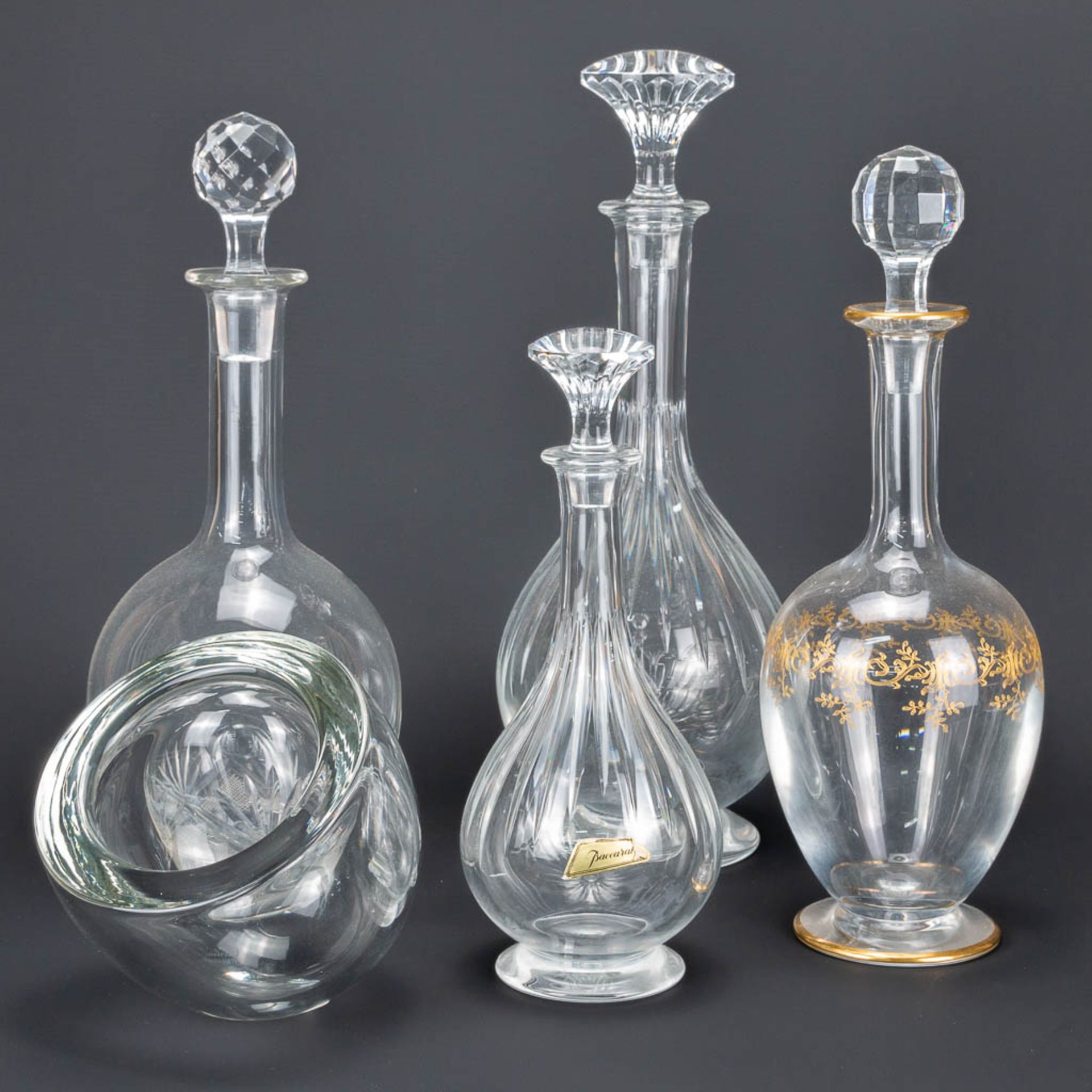 An assembled collection of 3 Baccarat decanters, a glass decanter and a Barbini Murano glass paperwe