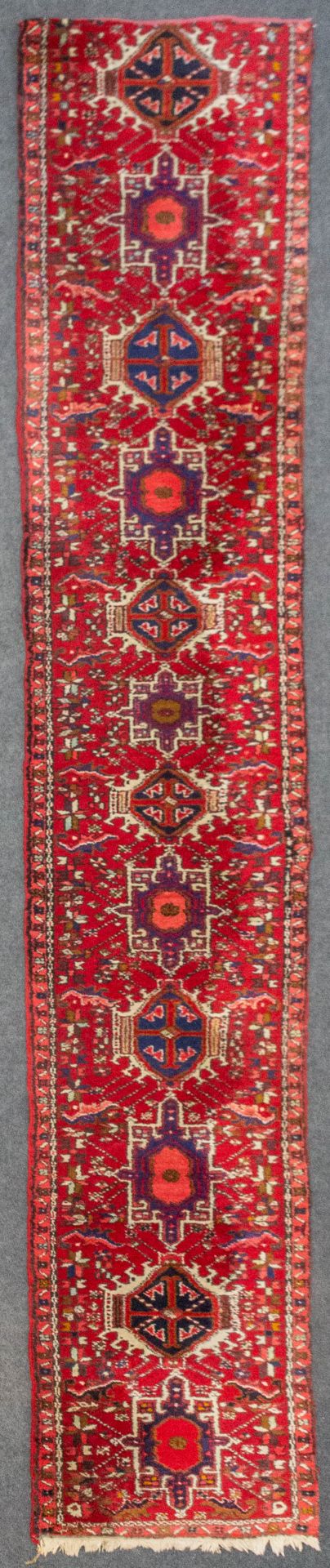 An Oriental hand-made carpet, Hamadan. (389 x 71 cm).