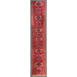 An Oriental hand-made carpet, Hamadan. (389 x 71 cm).