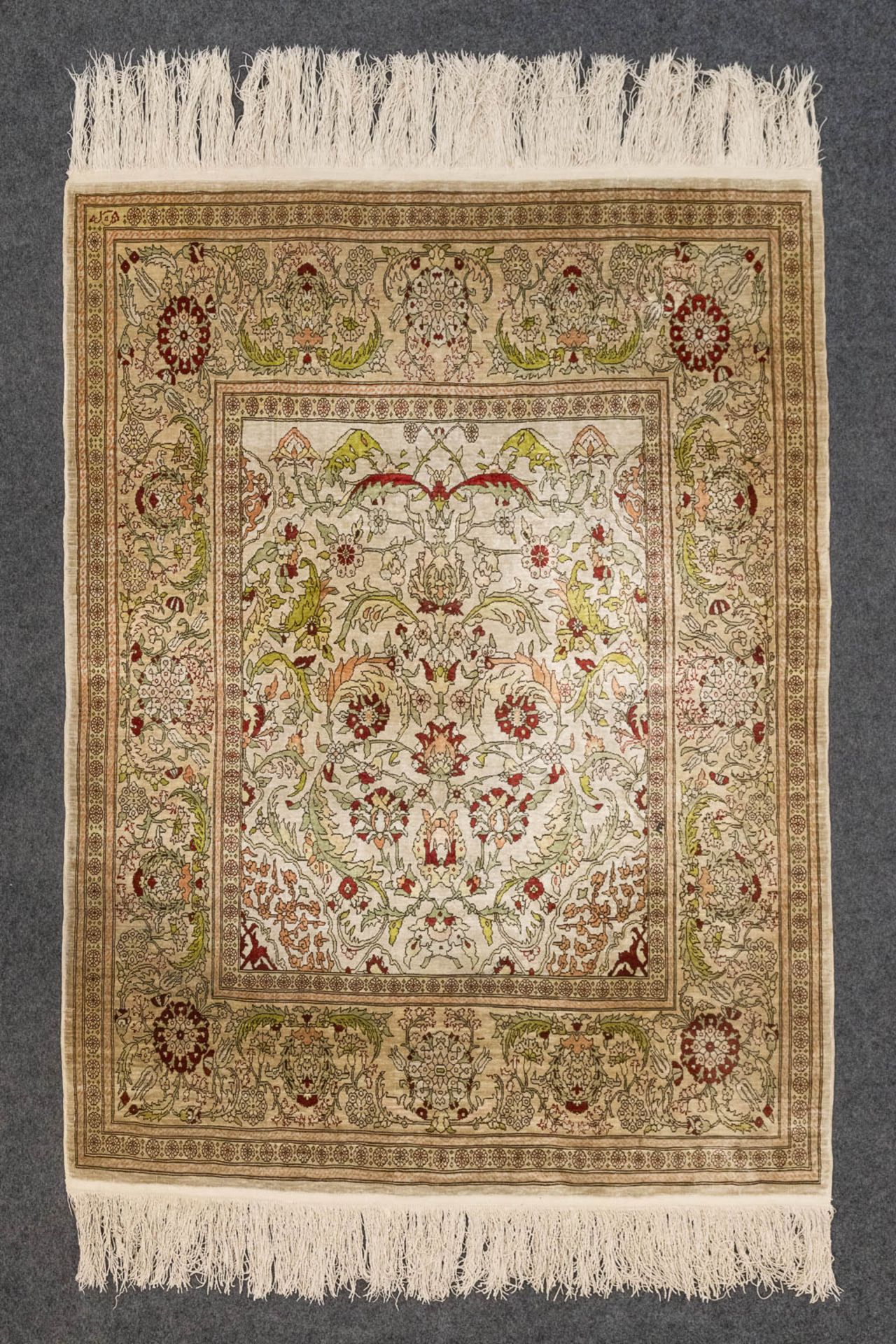 An Oriental hand-made carpet made of silk, Hereke. (135 x 102).