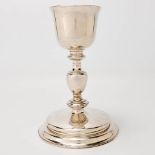 An antique chalice made of silver and marked Calix Decimalis 1725. Illegibly marked on the base, pro