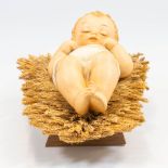 A Hummel porcelain statue of baby Jesus lying in the crib, 78 VI. (13 x 27,5 x 10 cm)