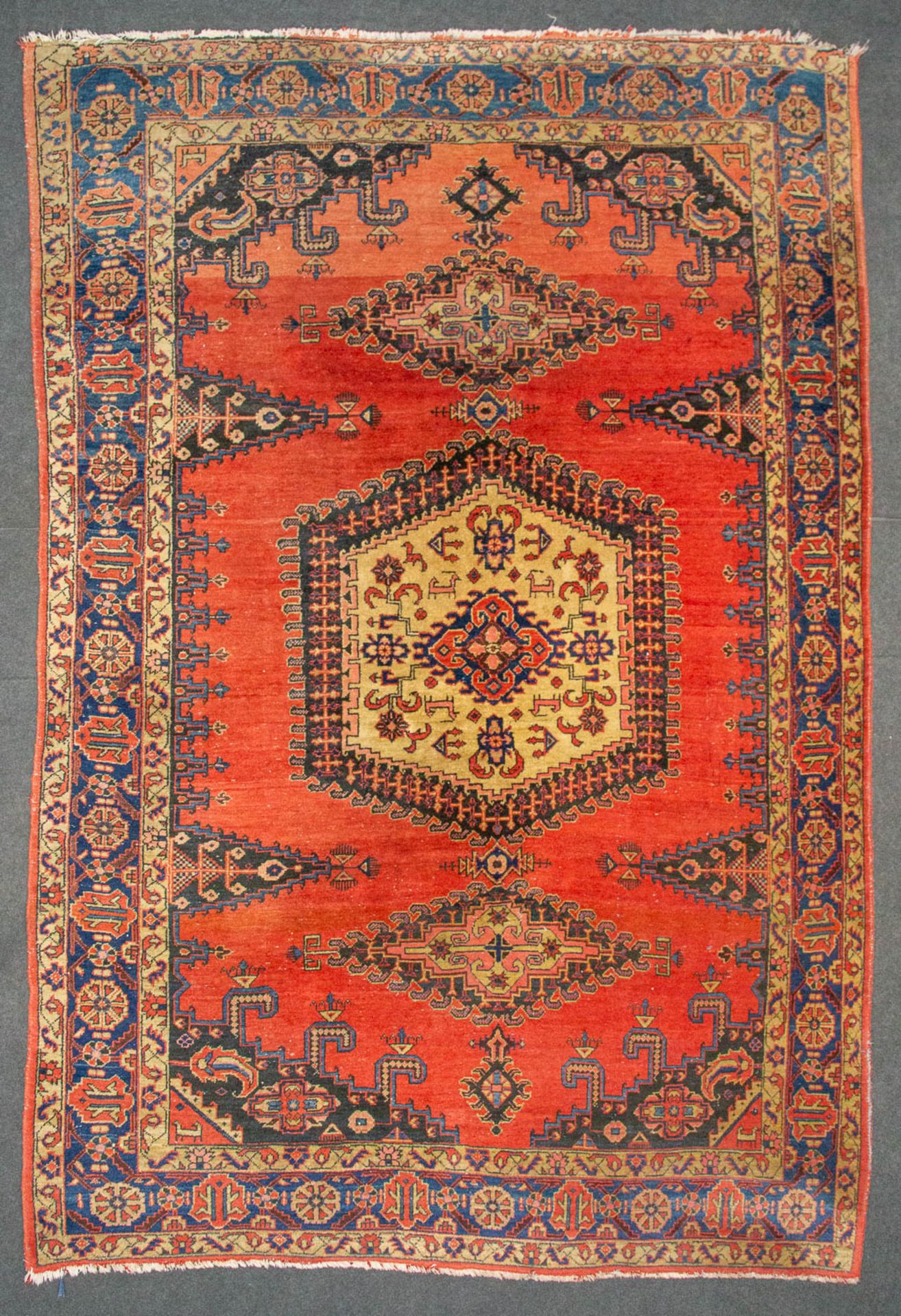 An Oriental hand-made carpet. (330 x 215 cm).