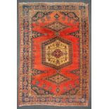 An Oriental hand-made carpet. (330 x 215 cm).