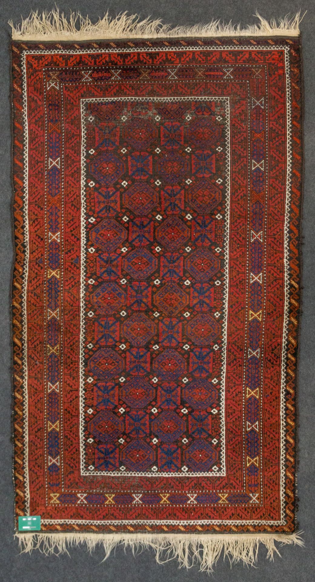 An Eastern hand-made carpet. (114 x 195 cm).
