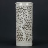 An antique vase made of porcelain with ajoured edges and decorated with blossoms. Probably European,