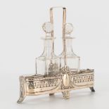 A silver basket with oil and vinegar bottles, pepper and salt bowls. Marked 800 and with half moon,