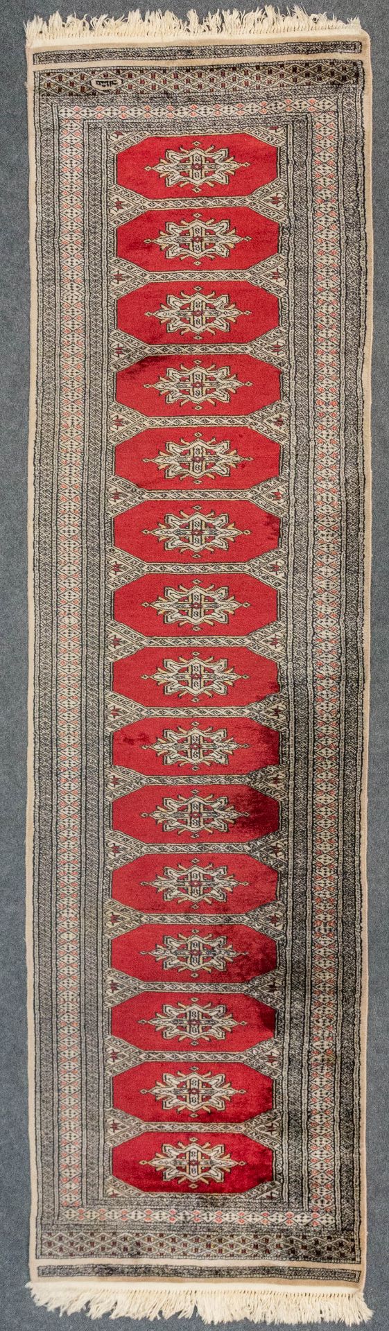 An Oriental hand-made runner carpet Bokhara (285 x 79 cm).